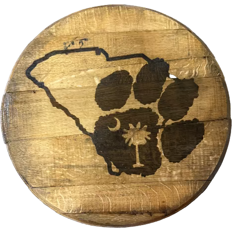 Wooden coaster with a South Carolina map design on a blue surface